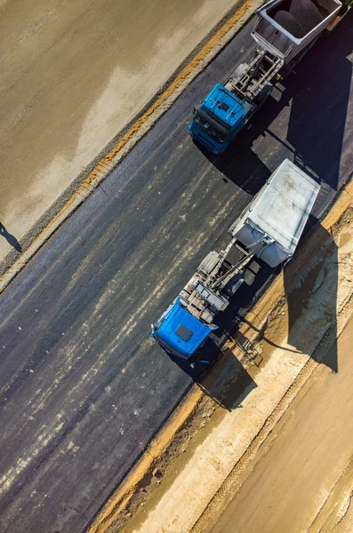 Road rollers working on the construction site aerial view