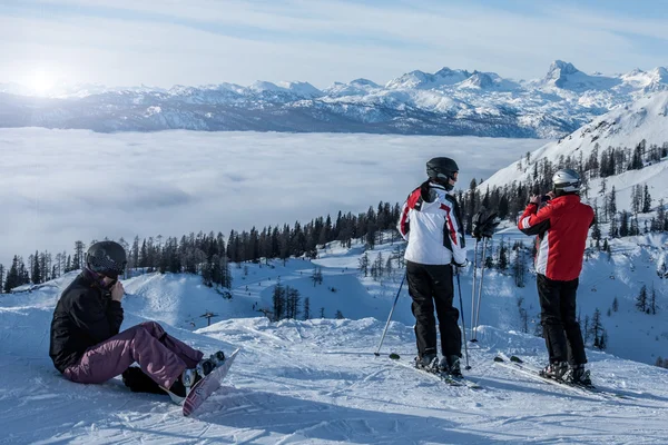 Skiers watching sunset