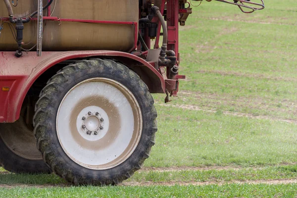 Spraying the herbicides on the green field