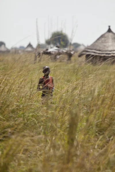 Lone boy in grass in South Sudan
