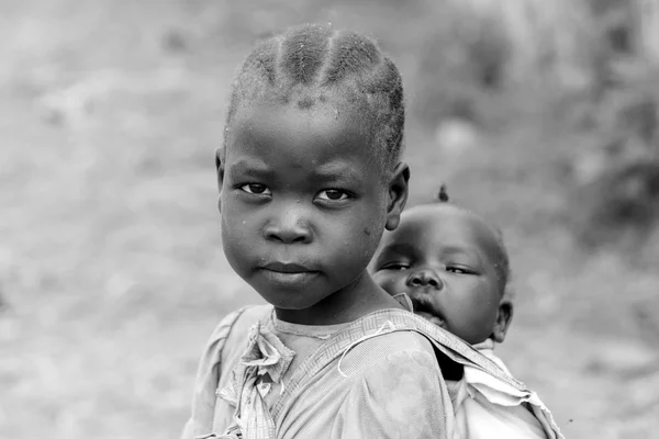 Girl carrying her sister in South Sudan