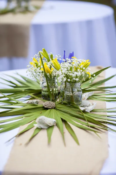 Flowers in mason jars at reception