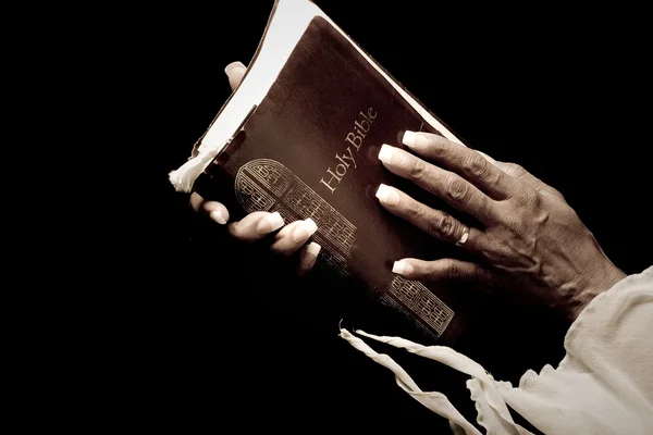 Elderly hands holding bible