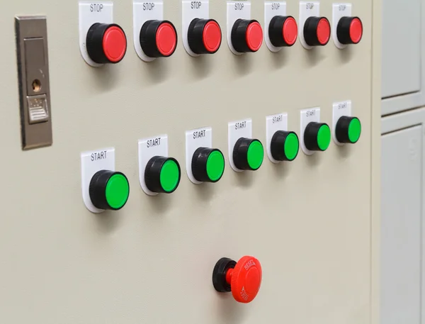 Red emergency and stop switch with green start buttons.