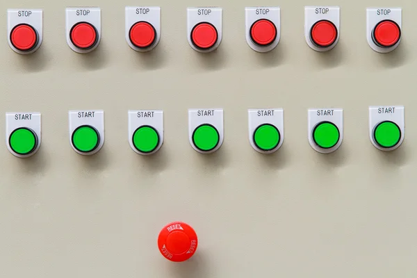 Red emergency and stop switch with green start buttons.