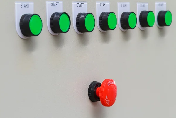 Red emergency stop switch and reset with green start buttons.