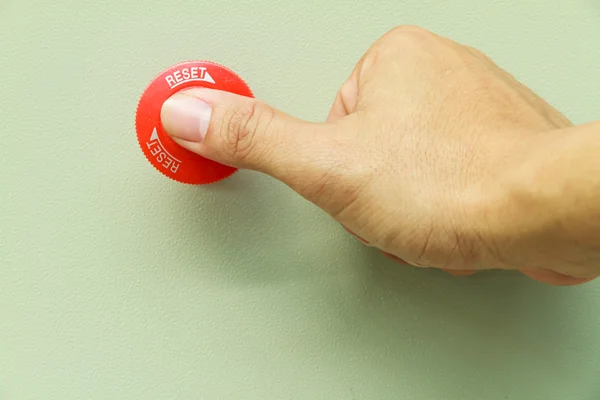 Thumb touch on red emergency stop switch