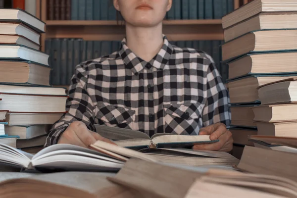 A stack  of many  books front person