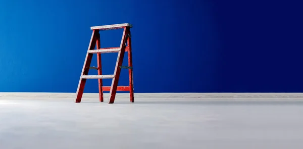 Red Wooden ladder on blue background