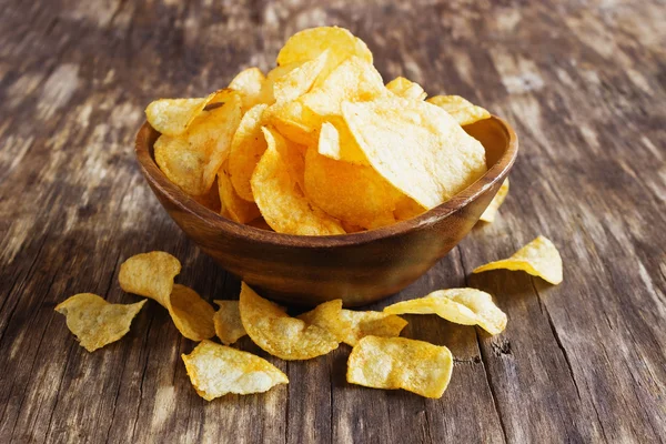 Potato chips in a wooden bowl