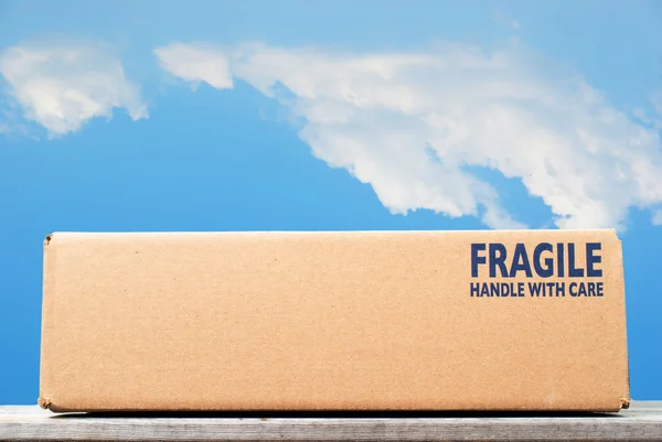 Shipping box with fragile handle with care as notice against blu