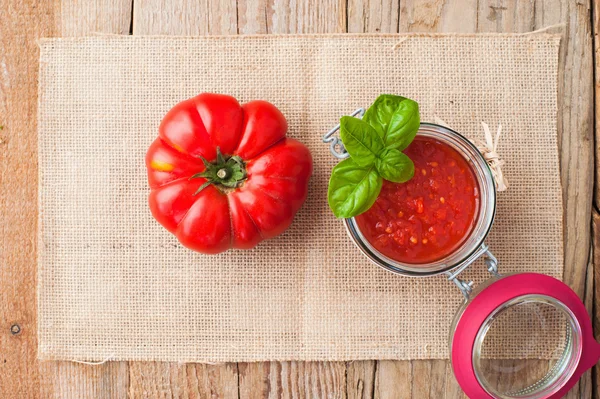 Tomatoes and tomato sauce, tomato puree on a wooden rustic table