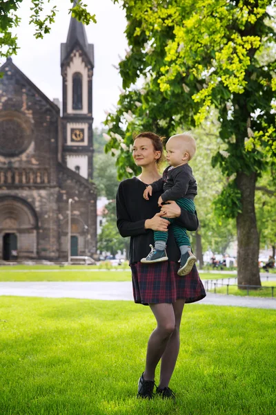 Family of Tourists on the Background of Church of St. Cyril and Methodius in the Karlin, Karlinske namesti, Prague, Czech Republic.