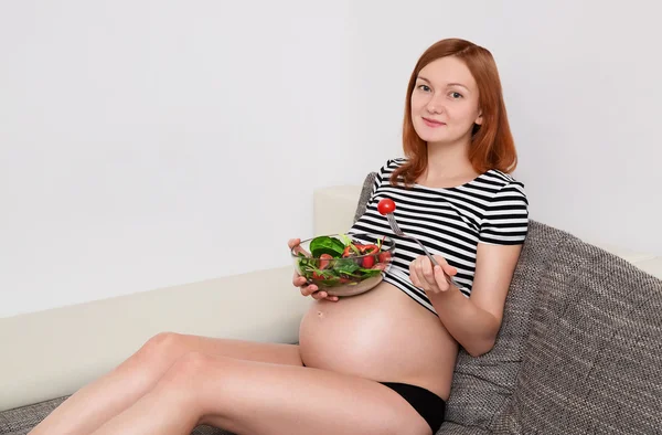 Pregnant woman with a bowl of vegetables