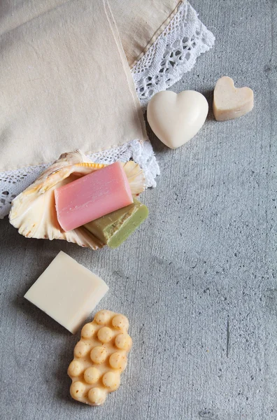 Handmade soaps, elegant towel, shell.