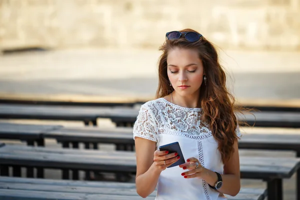 Hipster girl reads sms.