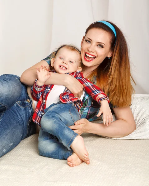 Mother and baby daughter in plaid shirt