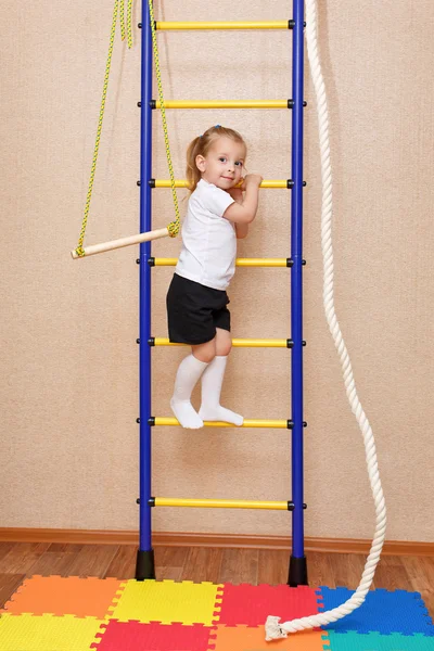 Little girl climbs the ladder