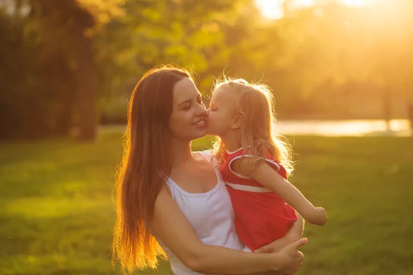 Daughter kissing mother