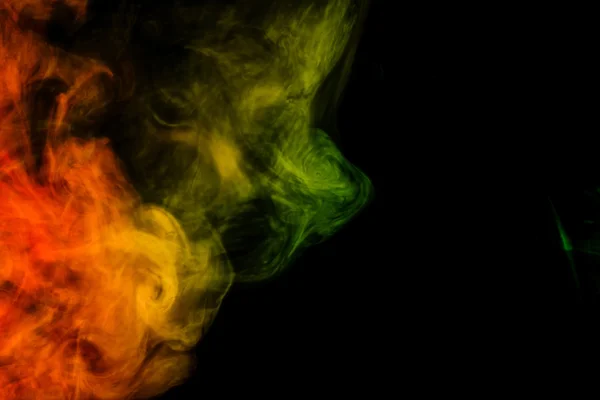 Abstract red and green smoke hookah on a black background.