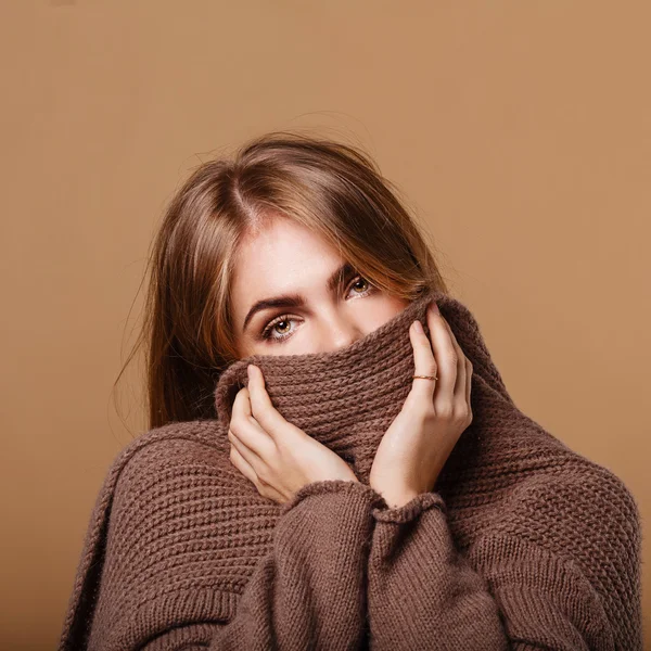 Girl wrapped in a warm sweater. Girl is sick.