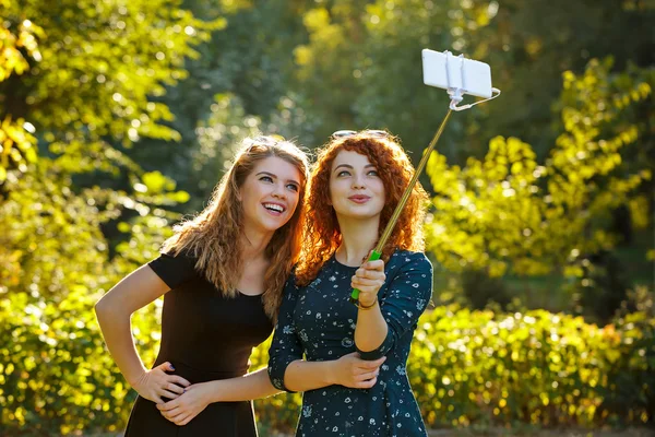 Two girls make selfie and smile.