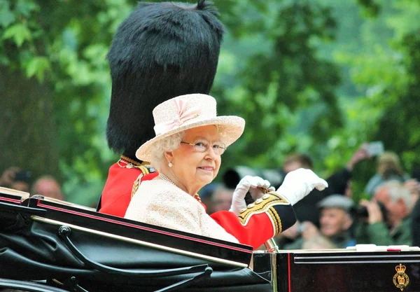 LONDON - JUNE 13: Queen Elizabeth II and Prince Philip seat on the Royal Coach at Queen\'s Birthday Parade, also known as Trooping the Colour, on June 13, 2015 in London, England.