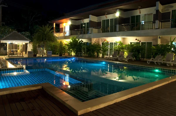 Resort with swimming pool at night