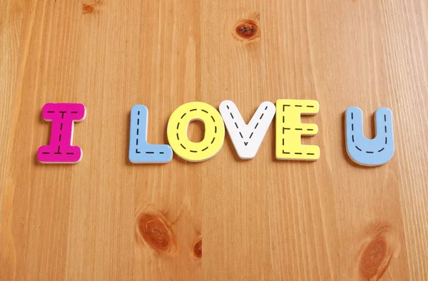 I LOVE YOU, IOU,spell by woody puzzle letters with woody backgro