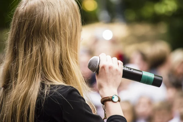 The girl in the street singing