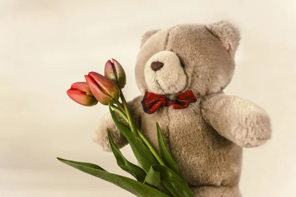 Soft toy bear with flower