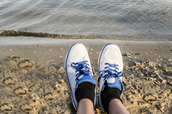 Shoes on a background of sand and sea vacation