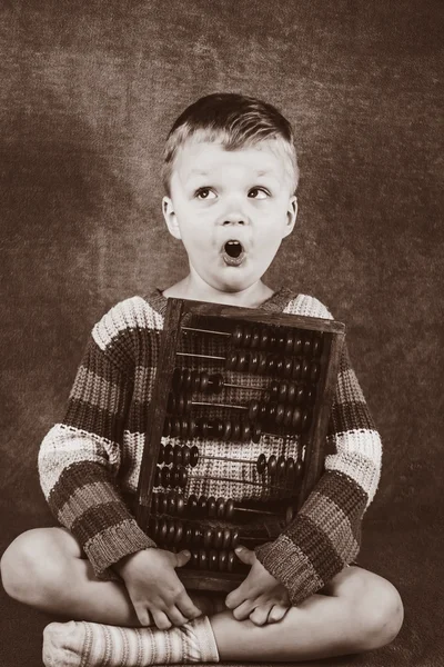 Boy learning to count on wooden accounts