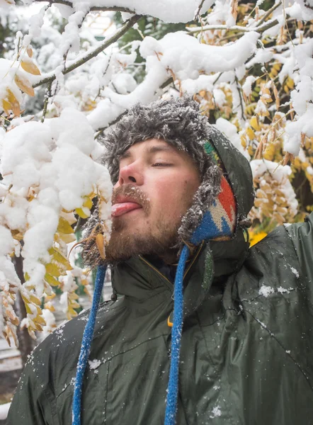 Wintery scene of shivering man in snowstorm