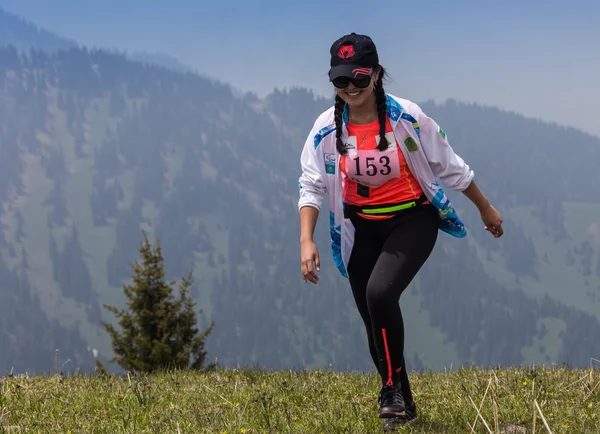 ALMATY, ALMATY DISTRIKT,KAZAKHSTAN - MAY 22, 2016: Open competition SKY RANNING 2016 held in Eliksay gorge. A girl runs up to the mountain named Bukreeva participating in the competition