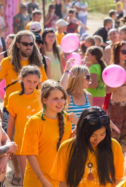 A large number of people in the colorful outdoor festival