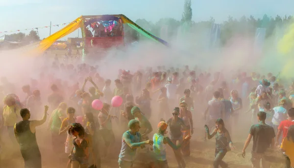 A large number of people in the colorful outdoor festival