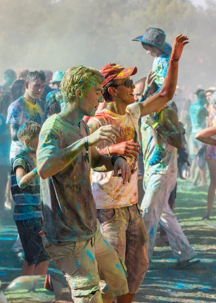 A large number of people in the colorful outdoor festival