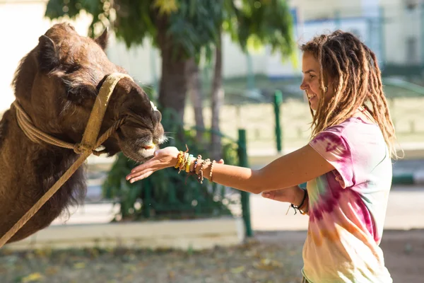 Tourists children riding camel