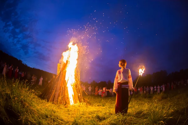 People celebrate the holiday and Russian dance in a circle around  sacred fire
