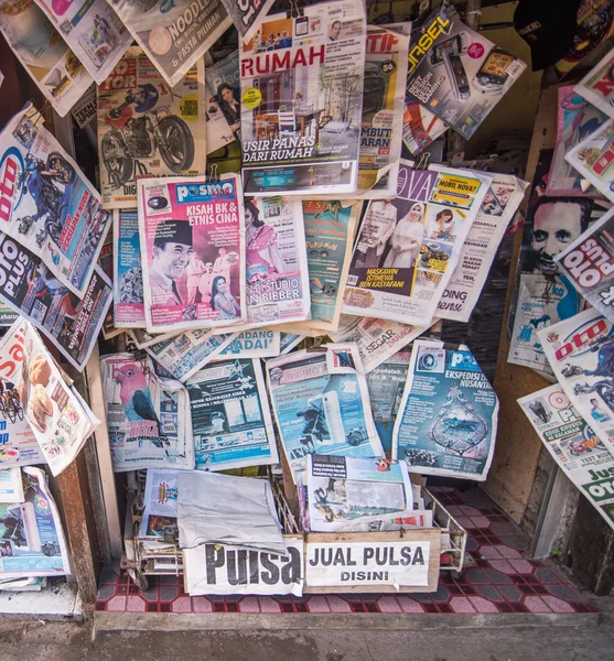KUTA,  BALI, INDONESIA-AUGUST 16  :A newsstand with many daily newspapers on the sidewalk of a street in KUTA capital. Indonesia has more than 600 state owned newspapers and media agencies.