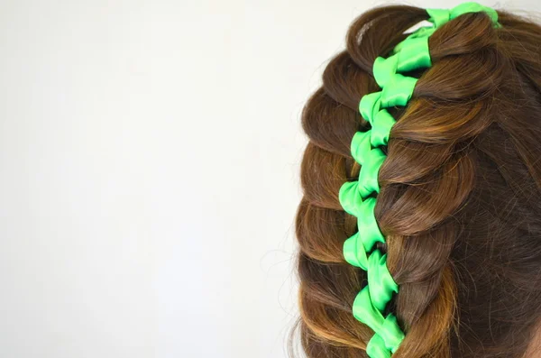 Hair weave with green ribbon