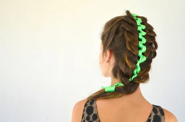 Hair weave with green ribbon