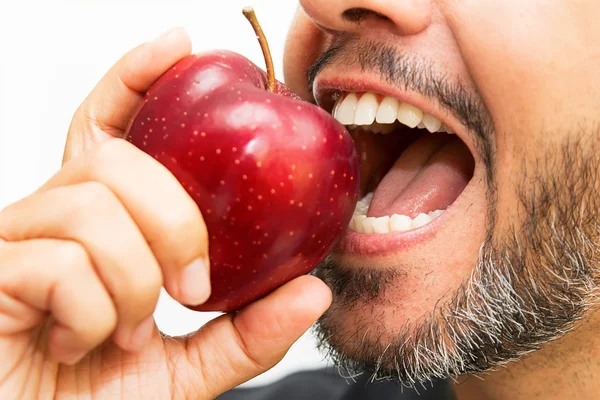 Closeup of man with beard biting an apple