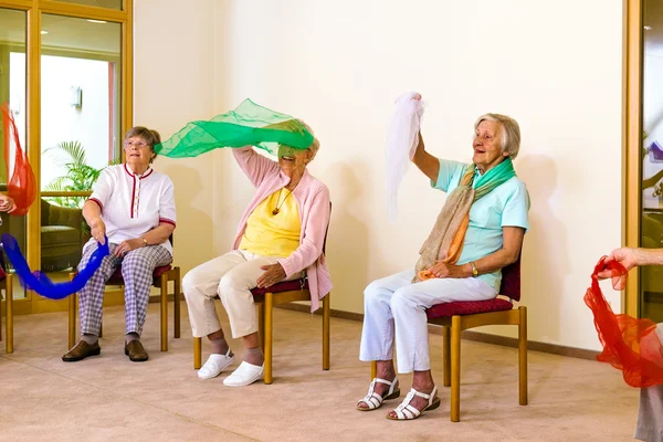 Women doing exercises in chairs