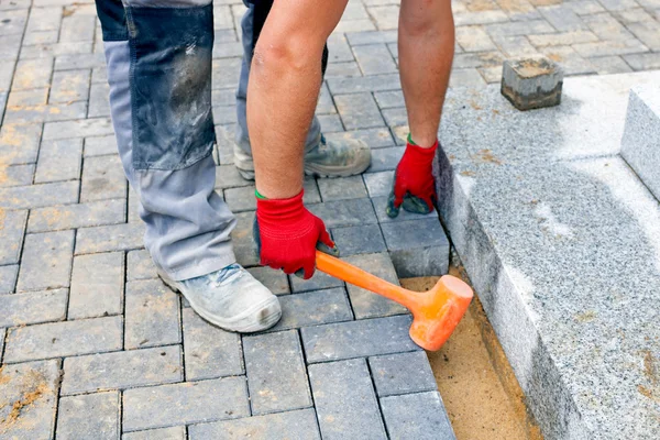 Bricklayer building up patio