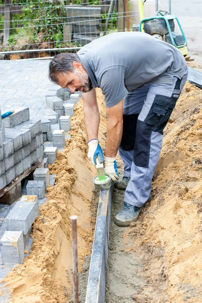 Worker puts stone slabs