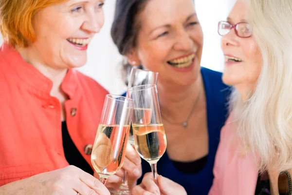 Women Tossing Glasses of Wine