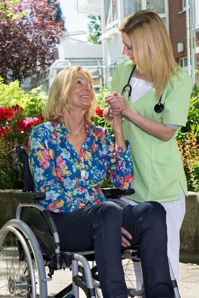 Nurse Standing Beside Senior Woman