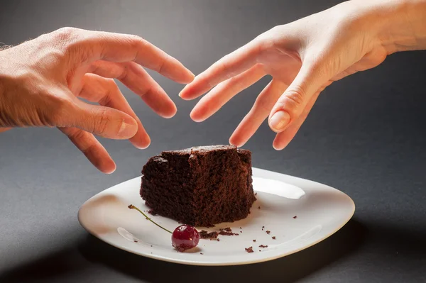 Concept with hands and chocolate cake